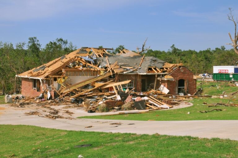 Damaged roof on Oklahoma home showing insurance claim decision
